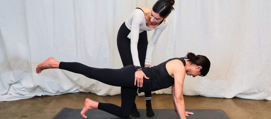 Pilates instructor working with a client online